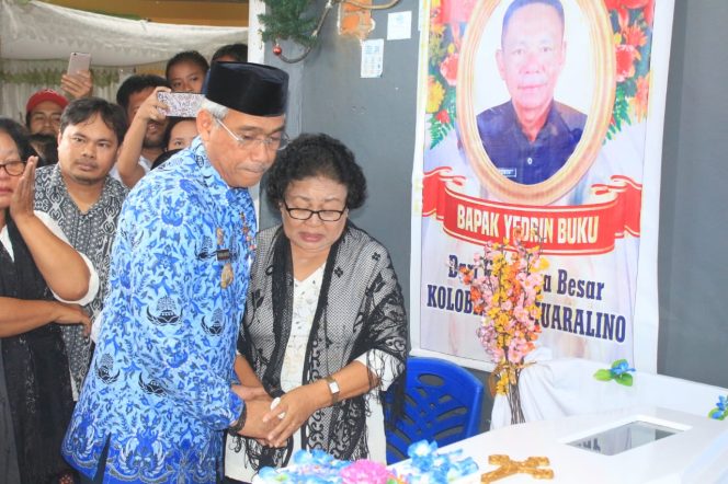 
					Bupati Luwu Timur, H.M.Thorig Husler memeluk salah seorang kerabat Almarhum Yedrin dan memandangi jenazah Yedrin